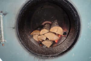 Burning logs in a round oven.